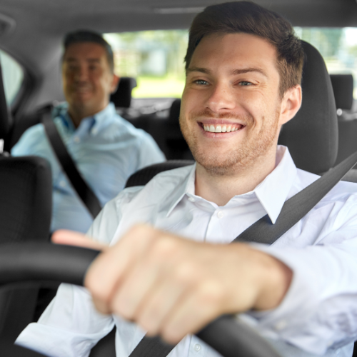 Smiling private driver with a happy passenger during a comfortable ride